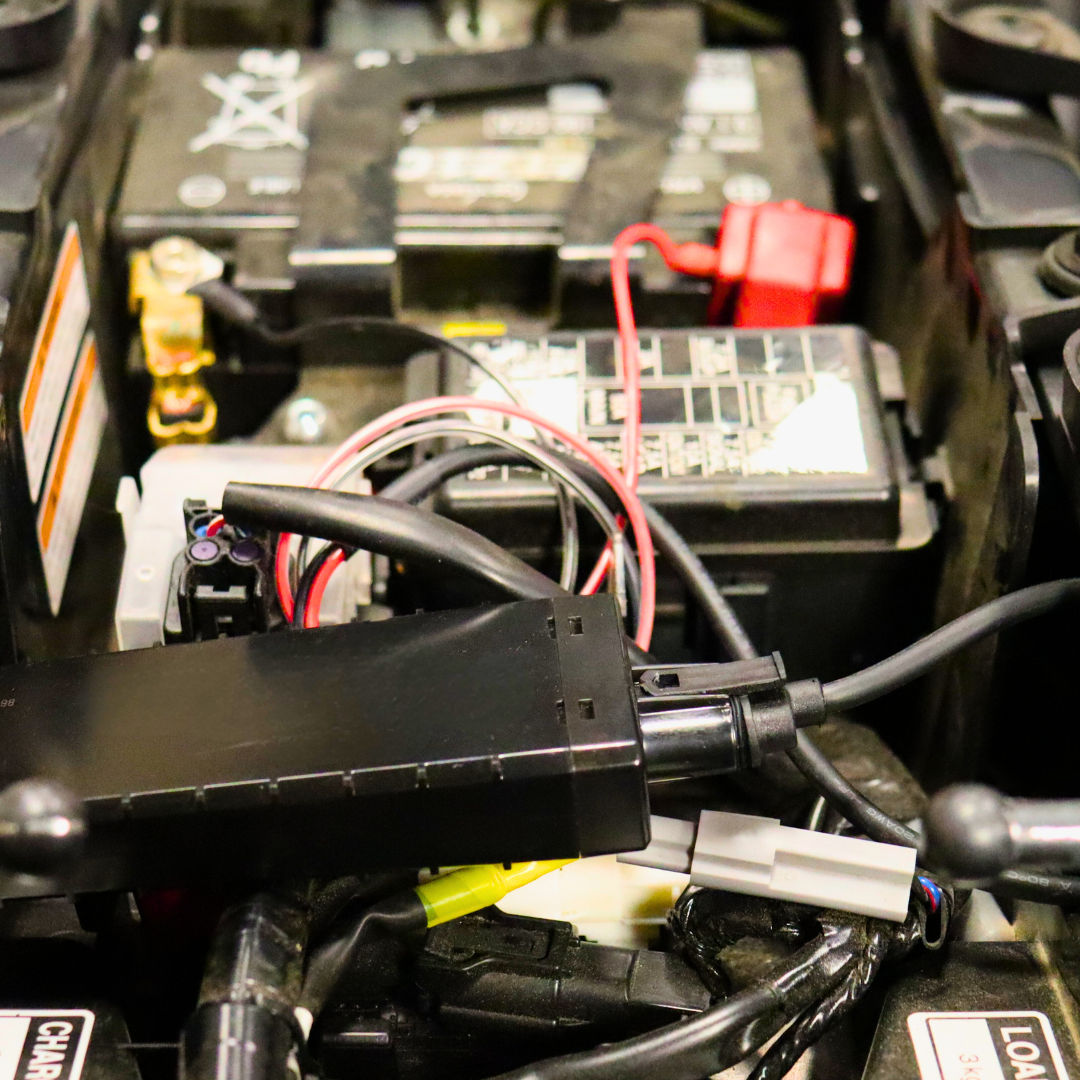 Close-up of motorcycle battery and WhereSafe Easy Connect Tracker installed