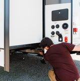 Magnetic GPS tracker being installed on an RV